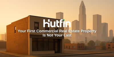 A refined two-story brick commercial building labeled “Main Street” bathed in warm morning light, symbolizing growth and progress after the first deal.