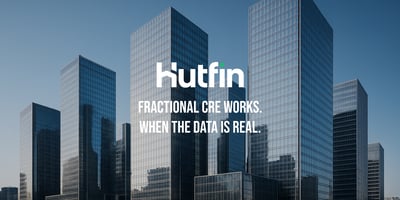 A cluster of tall, modern glass office towers reflecting the skyline in bright daylight, creating a dense and contemporary commercial district.