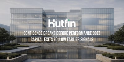 Modern glass office building reflected in a water feature, representing stability and transparency in commercial real estate operations.