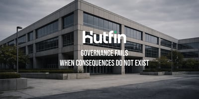 Modern commercial office building viewed from the exterior under an overcast sky, conveying institutional structure and permanence.