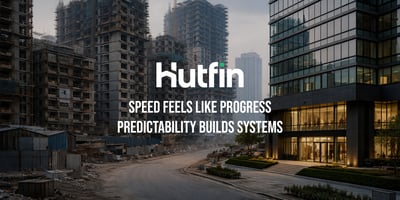 Urban construction site with unfinished high-rise buildings alongside a completed modern office building, highlighting contrast between rapid development and structured stability.