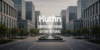 Symmetrical modern office buildings lining a wide, empty boulevard viewed from a centered perspective.