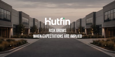 Symmetrical view of modern commercial buildings lining a quiet roadway at dusk, conveying order, scale, and long-term structural planning.