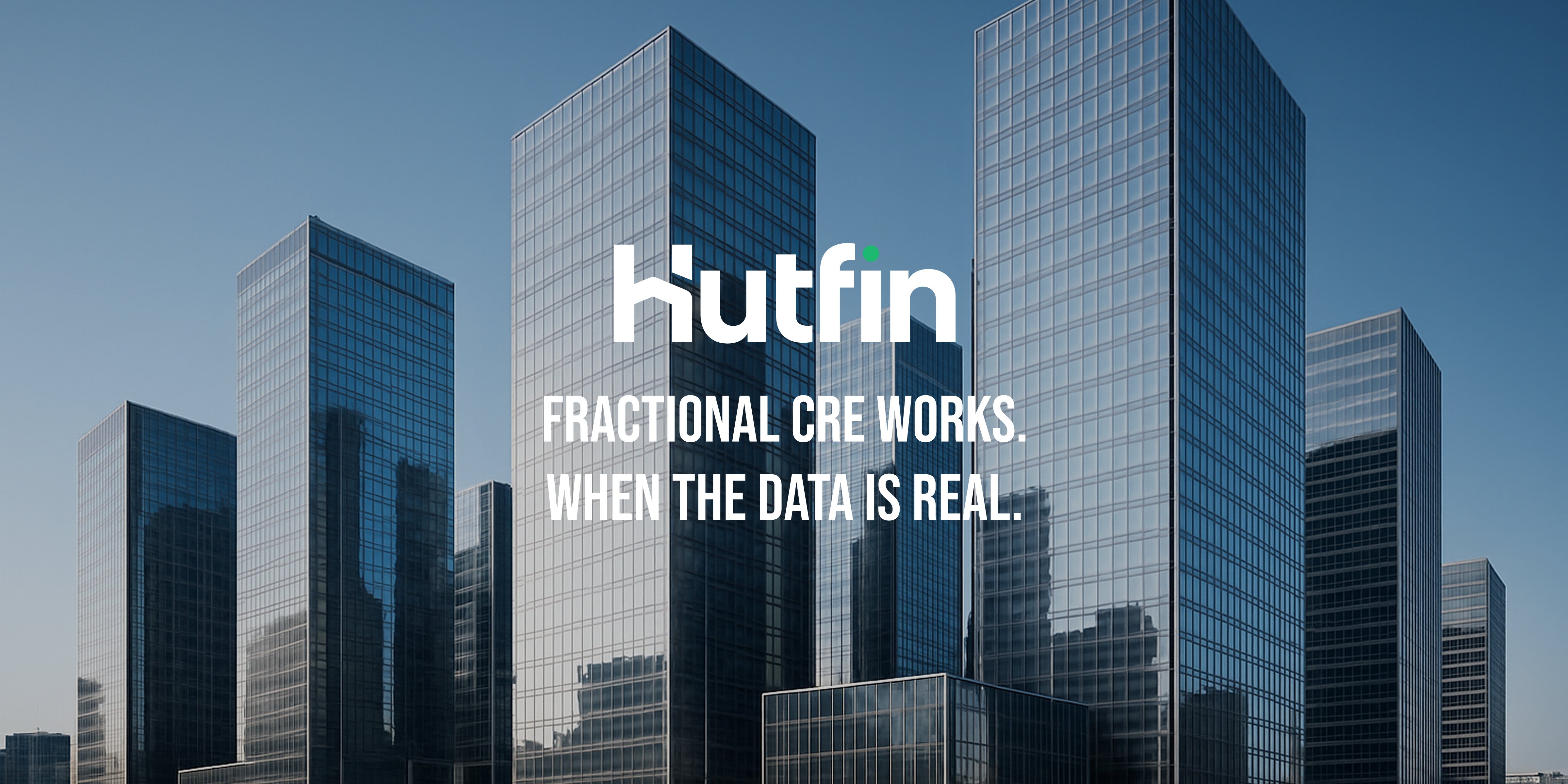 A cluster of tall, modern glass office towers reflecting the skyline in bright daylight, creating a dense and contemporary commercial district.