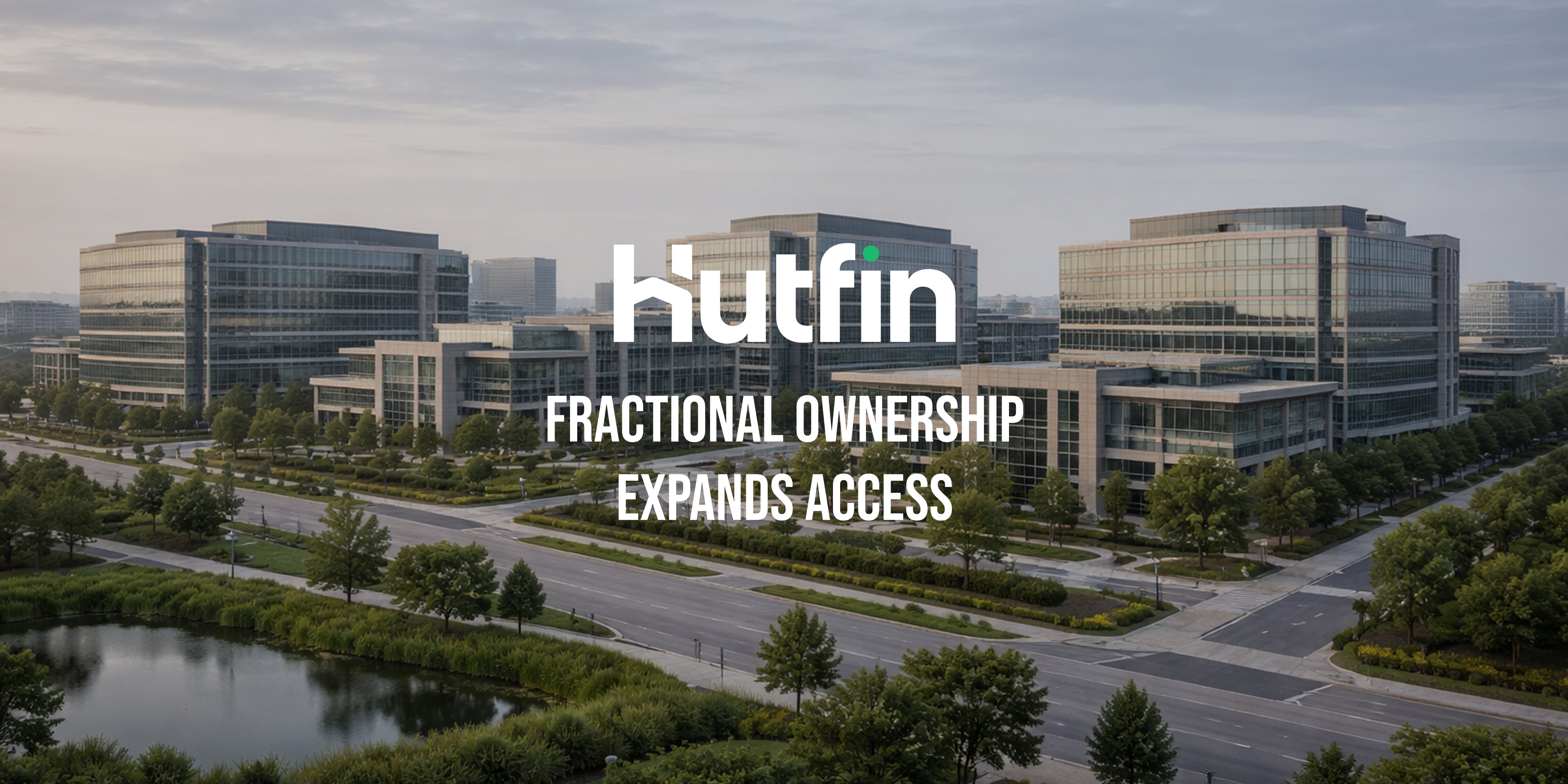 Aerial view of a modern office campus with multiple glass commercial buildings, landscaped roads, and surrounding greenery.