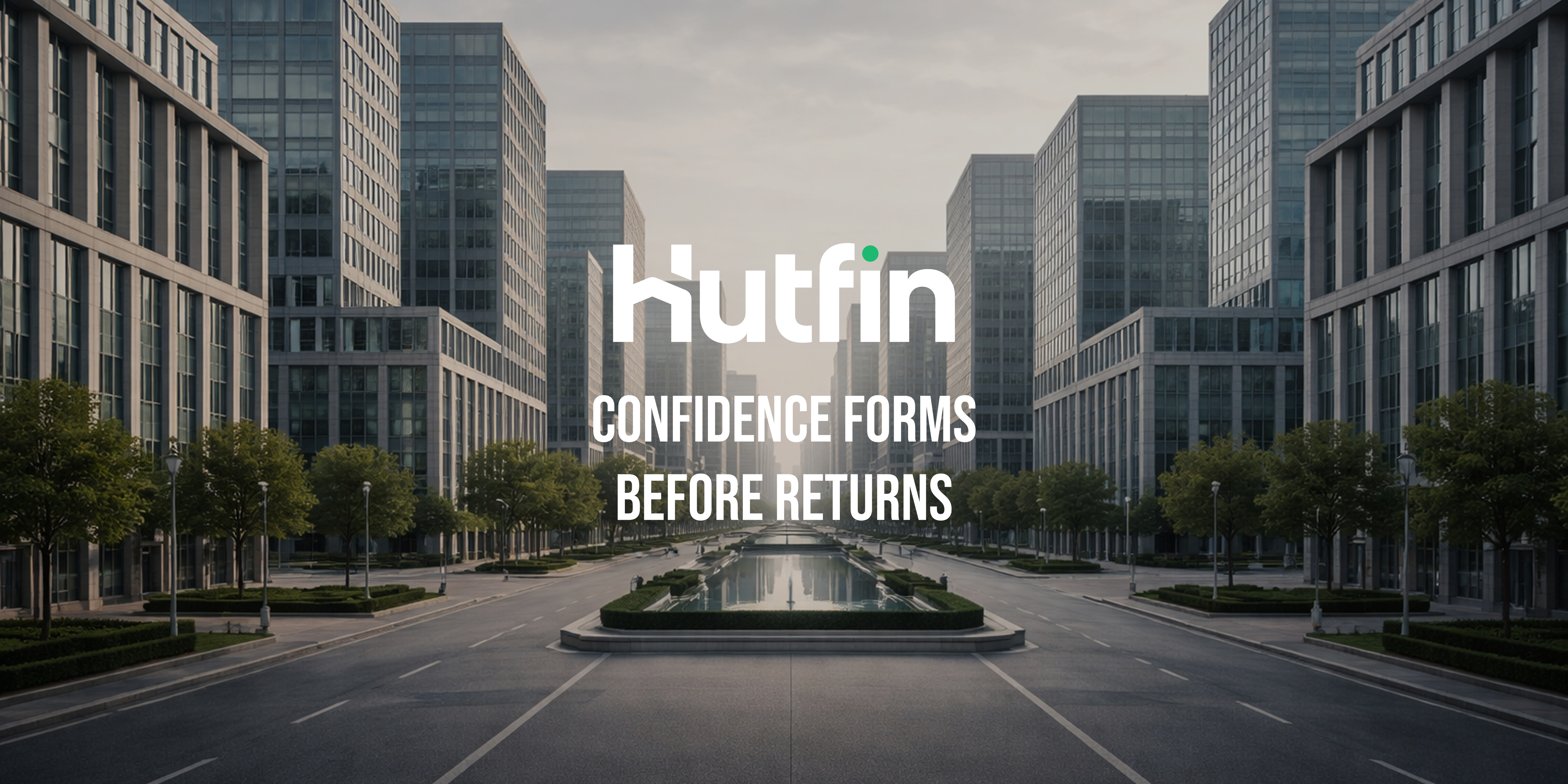 Symmetrical modern office buildings lining a wide, empty boulevard viewed from a centered perspective.