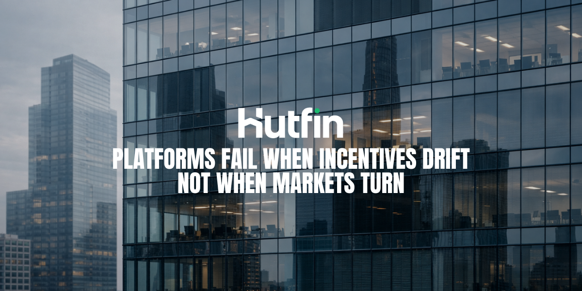 Modern glass office building with partially visible interior floors and reflected city skyline.